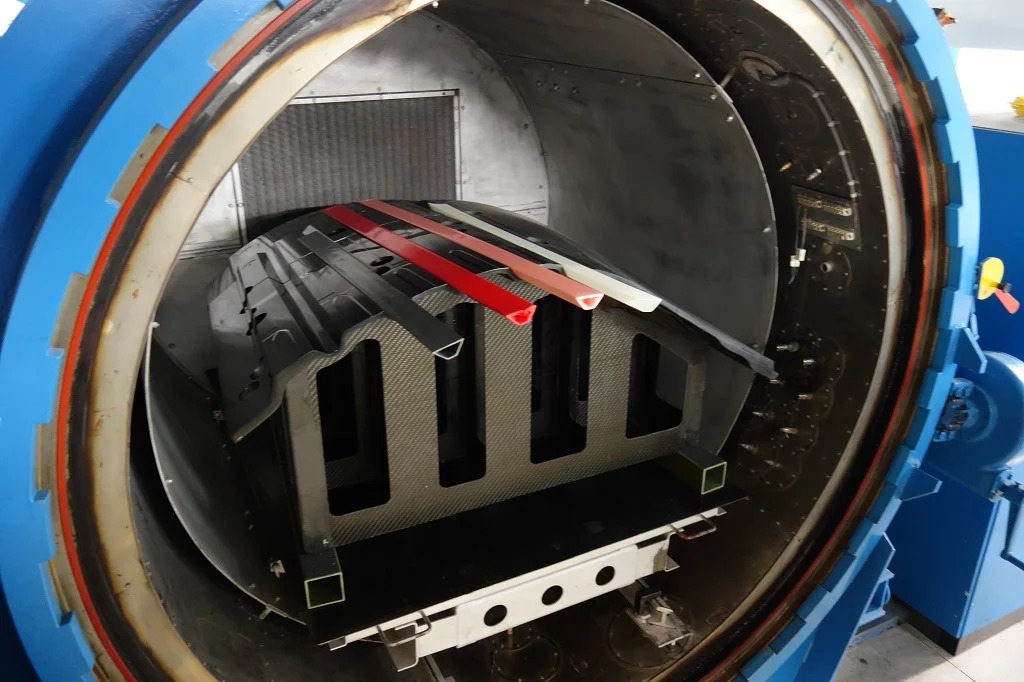 Prepreg composite component inside an open autoclave